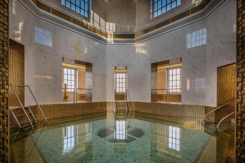 a large swimming pool in a building with water in it at Royal Palace in Turčianske Teplice