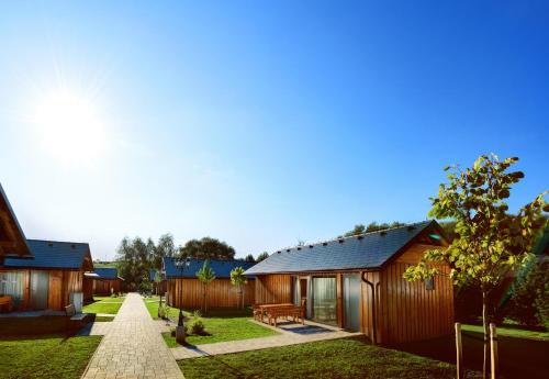 a row of cottages with a path between them at Holiday Village Tatralandia in Liptovský Mikuláš