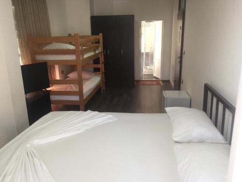 a bedroom with two bunk beds and a hallway at Ajro Rooms in Struga