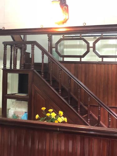 a group of yellow flowers sitting on a staircase at Khai Homestay in Hanoi