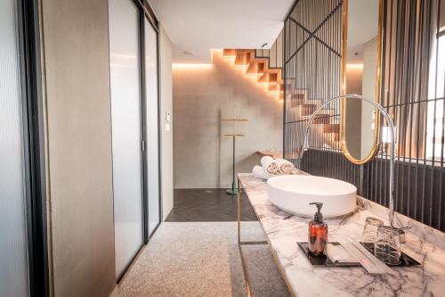 a bathroom with a tub and a sink on a counter at MOV Hotel Kuala Lumpur in Kuala Lumpur