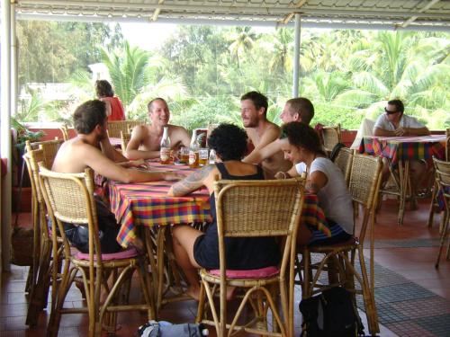 a group of people sitting at a table in a restaurant at Sealine Beach Resorts in Cherai Beach