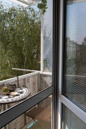 a balcony with a table and a window at Old Town Vintage Apartment Sturova in Košice
