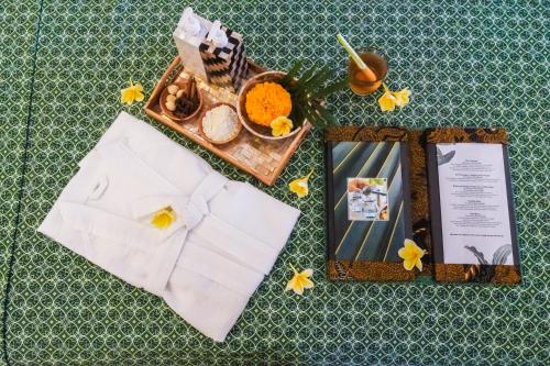 a table topped with a tray of food and flowers at FuramaXclusive Ocean Beach Seminyak Bali in Legian