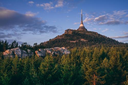 a church on top of a hill with trees at Pytloun Apartments Liberec in Liberec