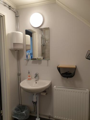 uma casa de banho com um lavatório e um espelho em Hook&Cup em Sorsele
