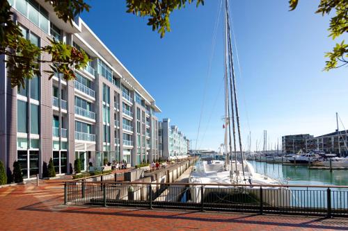 boats are docked at a dock in front of a large building at Sofitel Auckland Viaduct Harbour in Auckland