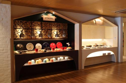 a shop with a display of dishes in a room at Heiseikan Shiosaitei Hanatsuki in Hakodate