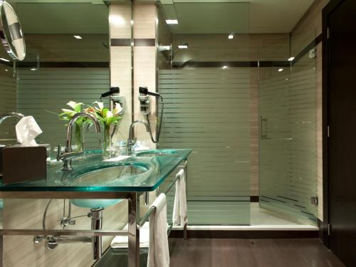 a bathroom with a green sink and a shower at Hotel Maydrit Airport in Madrid