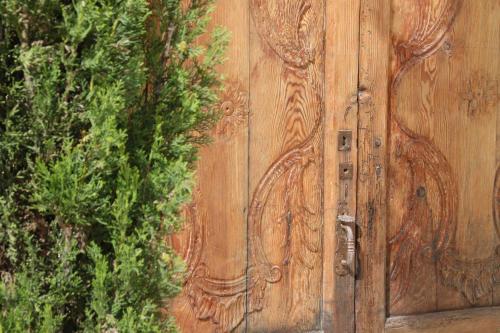 a wooden door with a carving on it at Villa Foia Vella - adults only in Benichembla