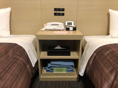 a bedroom with a bed and a desk at Hotel Route Inn Grand Asahikawa Ekimae in Asahikawa