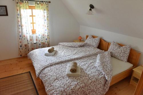 a bedroom with a bed with two towels on it at Vila Idila in Lendava
