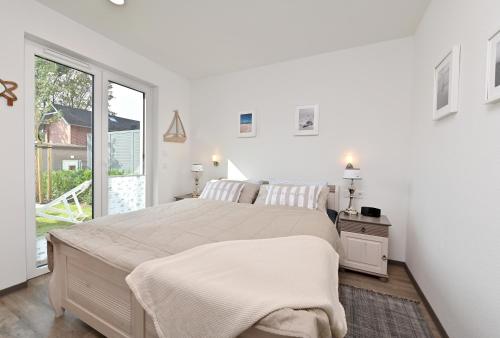 Postel nebo postele na pokoji v ubytování Ferienwohnung Strandgut