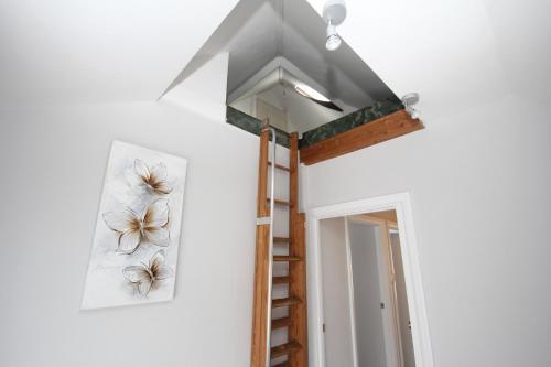 a room with a ladder and a painting on the wall at The Uxbridge House in Uxbridge
