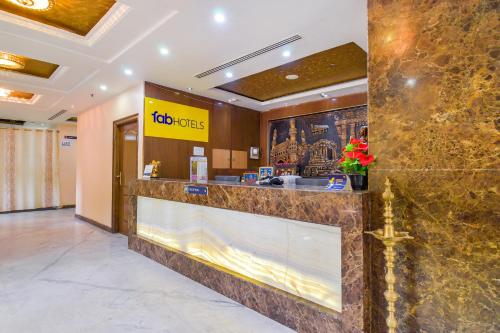 a lobby of a hotel with a reception counter at FabExpress Deccan Heritage Abids in Hyderabad