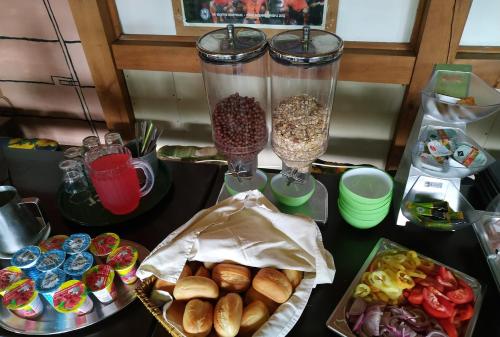 a table topped with bowls of food and containers of food at Fehérló Vendégház & Restaurant in Bük