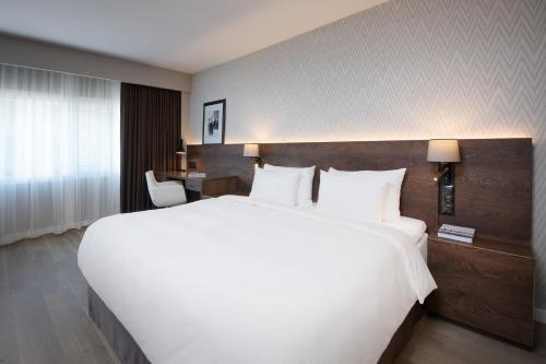 a large white bed in a hotel room at Radisson Blu Plaza Hotel, Oslo in Oslo