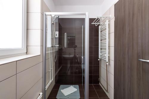 a bathroom with a shower with a glass door at HB Brilliant in Braşov