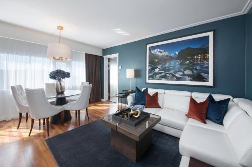 a living room with a white couch and a table at Radisson Blu Plaza Hotel, Oslo in Oslo