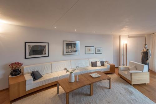 a living room with a couch and a table at Turm Chalet in Laces