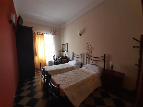 a bedroom with a bed and a dresser at Camere Del Re in Tarquinia