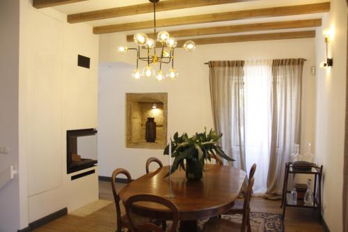 a dining room with a table and chairs and a chandelier at Pedra Nova in Castelo Novo
