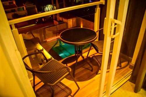 a balcony with a table and chairs on a porch at Ruvisha Beach Hotel in Negombo