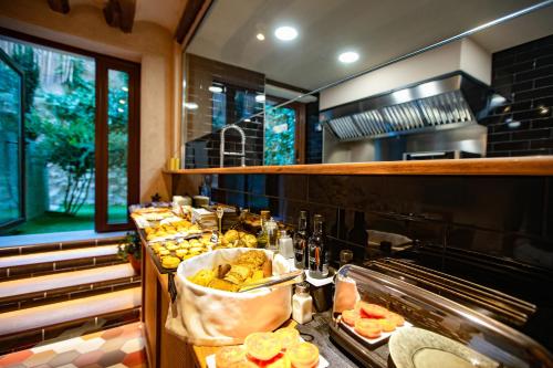a kitchen with a buffet of food on display at El Palauet del Priorat in Cornudella