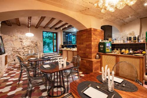 a restaurant with tables and chairs in a room at El Palauet del Priorat in Cornudella