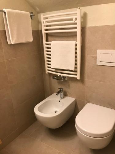 a bathroom with a toilet and a sink at Platzerhof in Monguelfo