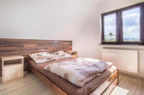 a bedroom with two beds and a window at Przystanek Zapotocze in Słopnice