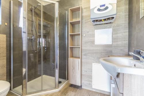 a bathroom with a shower and a sink at Przystanek Zapotocze in Słopnice