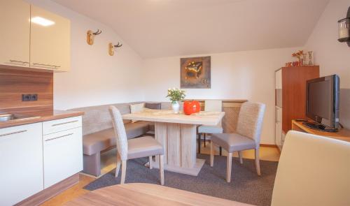 a kitchen and dining room with a table and chairs at apart.pitztal in Arzl im Pitztal