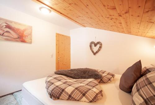 a bedroom with two beds and a heart on the wall at apart.pitztal in Arzl im Pitztal