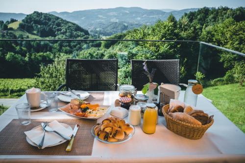 a table with bread and juice and baskets of food at WURZENBERG Hotel Lodges Südsteiermark in Gamlitz