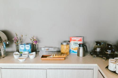 a kitchen counter with food on a counter top at Barelang Hotel Nagoya Batam in Nagoya