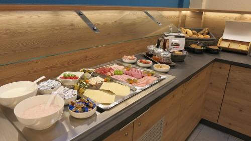 a buffet with a tray of food on a counter at Boardingroom in Filderstadt