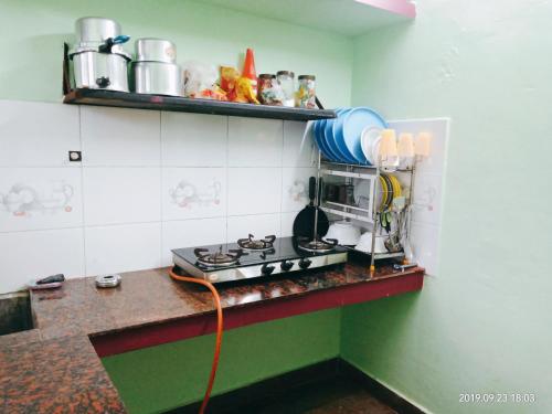 a kitchen with a coffee maker on a counter at Freshup & Stay in Chikmagalūr