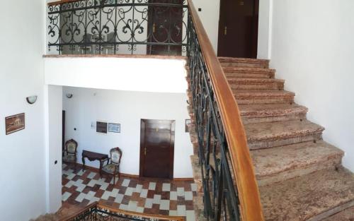a staircase in a house with a surfboard at Pensiunea Mayumi Moneasa in Moneasa