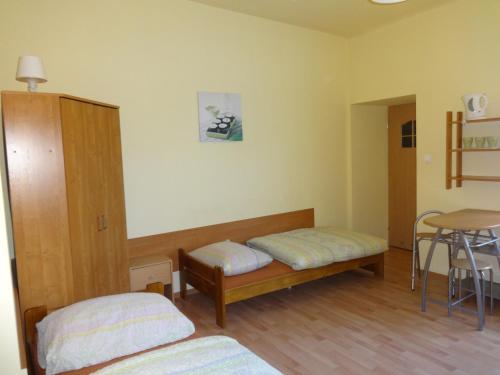a room with two beds and a table at Apartamenty NOCLEGI BĘDZIN in Będzin