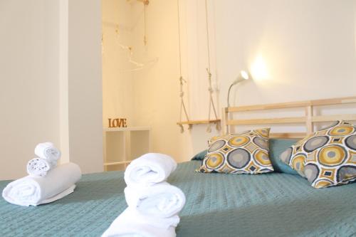 a bedroom with a bed with towels on it at Dimora Orfeo in Bologna