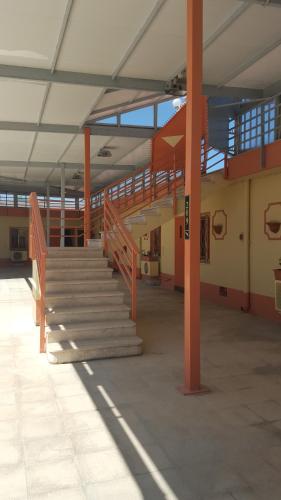a staircase in a building with orange poles and windows at HOTEL MARE PINETA in Bari