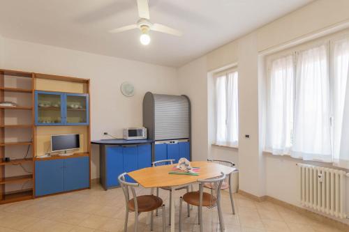 a kitchen with a table, chairs and a refrigerator at Residenza Adelaide in Finale Ligure