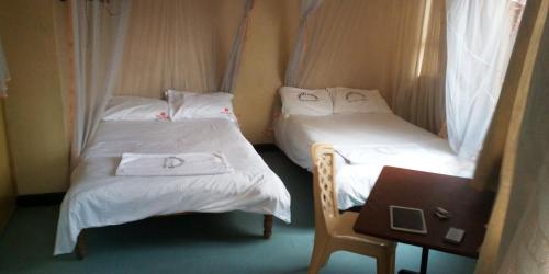 Postel nebo postele na pokoji v ubytování Hotel Jaffers Nairobi