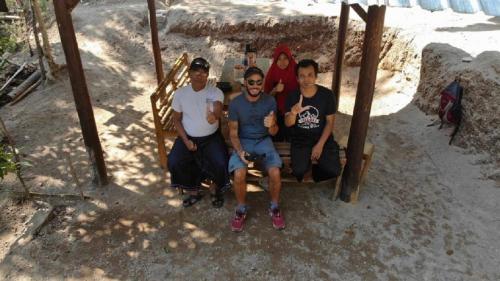 a group of men sitting on a swing at Tereng Wilis Jungle Inn in Tetebatu
