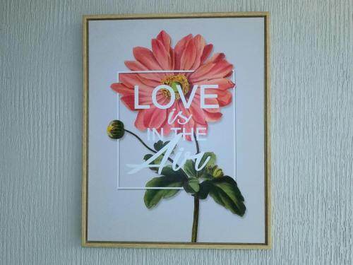 a picture of a flower with the words love is life at Bedugul Lake View Residence Unit B-6 in Bedugul