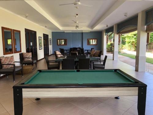 a pool table in the middle of a living room at cocoon apartment in Victoria