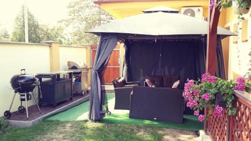 a gazebo with a table and a grill at Apartmány na kolonádě in Lednice
