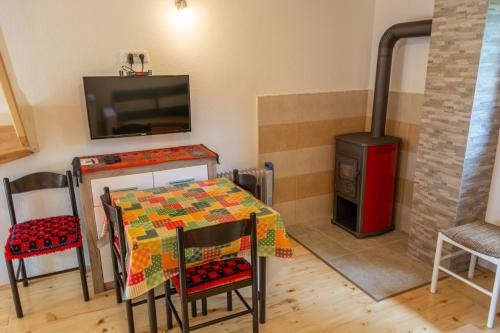 a dining room with a table and a stove at Small Montenegro in Žabljak