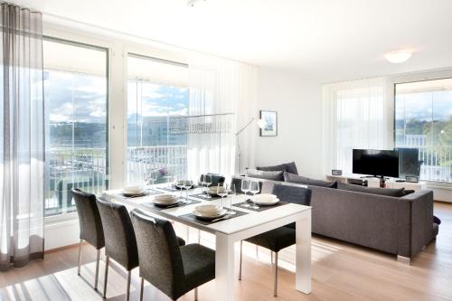 a living room filled with furniture and a large window at Aallonkoti Apartments in Helsinki